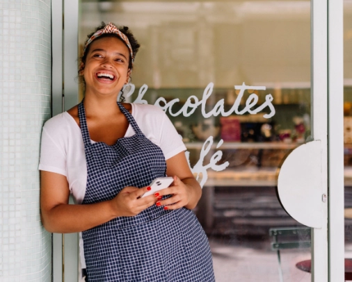 Business owner standing in front of their shop